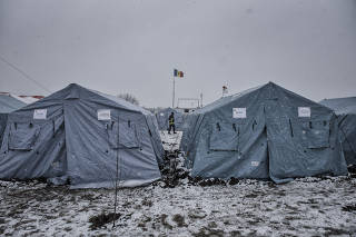 The Moldovan flag flies over a temporary camp for Ukrainian refugees in Palanca, Moldova, March 1, 2022. (Laetitia Vancon/The New York Times)