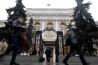 FILE PHOTO: People walk past the headquarters of Russia's Central Bank in Moscow