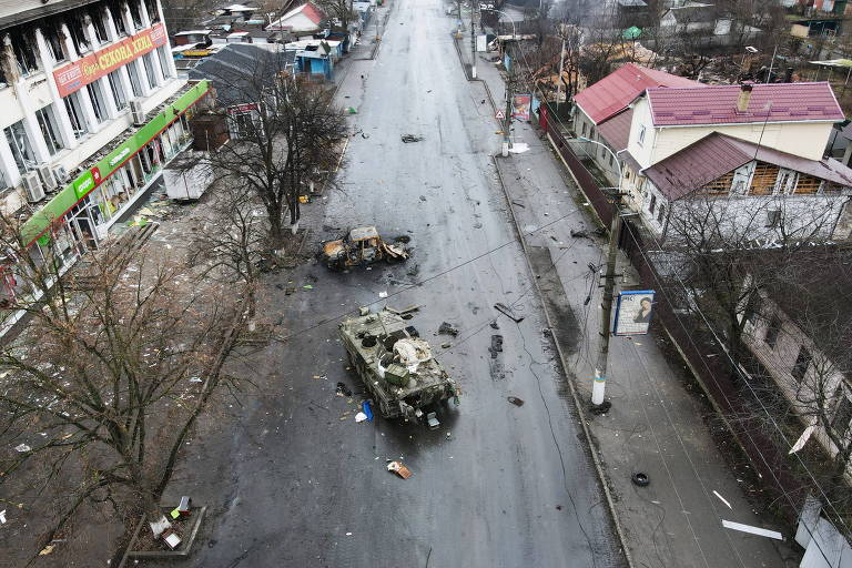 Um veículo blindado destruído é visto em uma rua no assentamento de Borodyanka,na região de Kiev