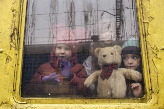 Children aboard a train evacuating people from Kyiv, Ukraine, March 3, 2022. (Lynsey Addario/The New York Times)