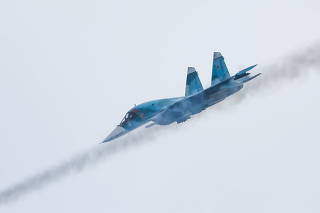 A Russian Sukhoi Su-34 fighter-bomber fires missiles during the Aviadarts competition outside Ryazan