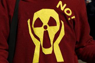 A man wears a jumper with a radioactivity hazard symbol resembling Munch's painting 