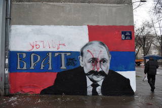 A mural of Russian President Vladimir Putin is vandalised, in Belgrade