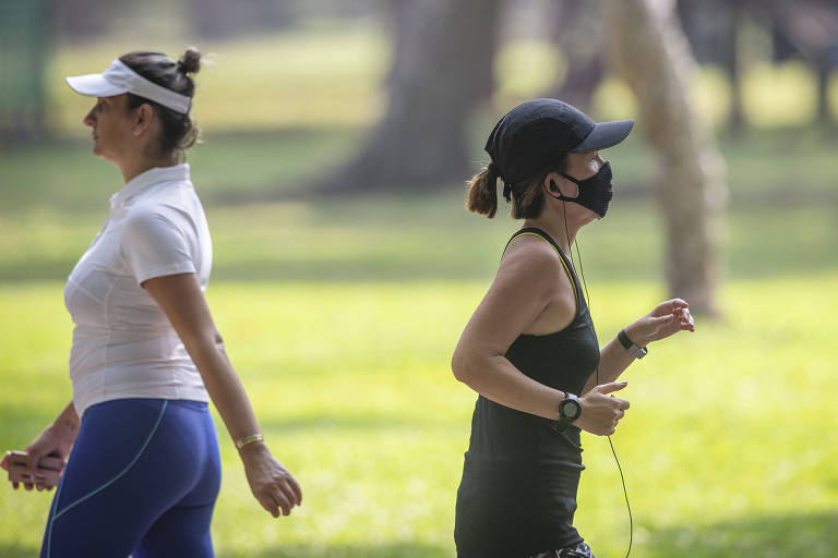 Pessoas se exercitam no parque do Ibirapuera, zona oeste de São Paulo, com e sem a máscara