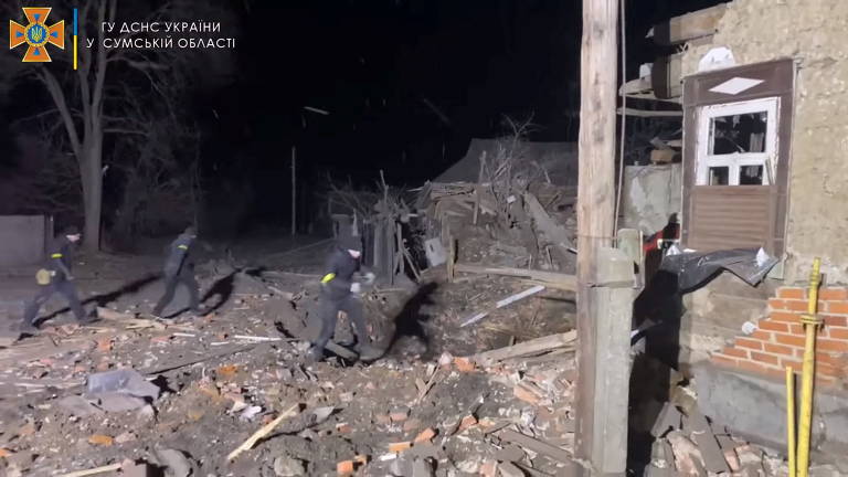 Equipes de emergência trabalham em meio aos escombros de residências bombardeadas em Lebedyn, em Sumy, norte da Ucrânia