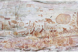 A photo provided by Jose Iriarte, an archaeologist at the University of Exeter in England, shows the ancient rock art at Serrania La Lindosa in Colombia, with a possible ground sloth indicated with a black arrow, center-right. (Iriarte et al., Royal Society B 2022 via The New York Times)