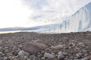 Scientists perform research field work at the edge of the Greenland Ice Sheet