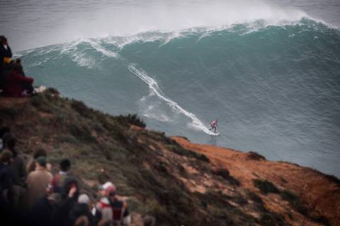 TOPSHOT - Portuguese surfer Nic Von Rupp rides a wave during the Tudor Nazare Tow Surfing Challenge at Praia do Norte in Nazare on February 10, 2022. (Photo by CARLOS COSTA / AFP)