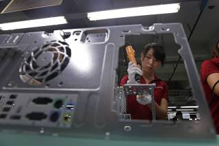 File photo of an employee working at a Foxconn factory in Wuhan
