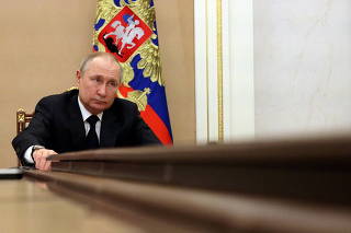 FILE PHOTO: Russian President Vladimir Putin attends a meeting with government members via a video link in Moscow