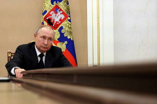 FILE PHOTO: FILE PHOTO: Russian President Vladimir Putin attends a meeting with government members via a video link in Moscow