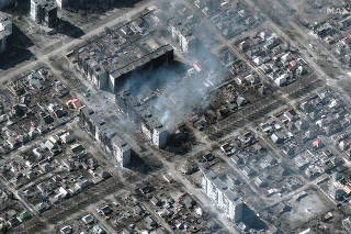 A satellite image shows burning and destroyed apartment buildings, in Mariupol