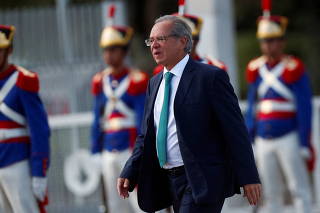 Brazil's Economy Minister Paulo Guedes walks before a national flag hoisting ceremony in front of Alvorada Palace in Brasilia
