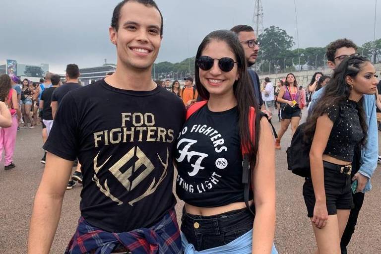 homem e mulher vestem camisas pretas com símbolos da banda americana Foo Fighters