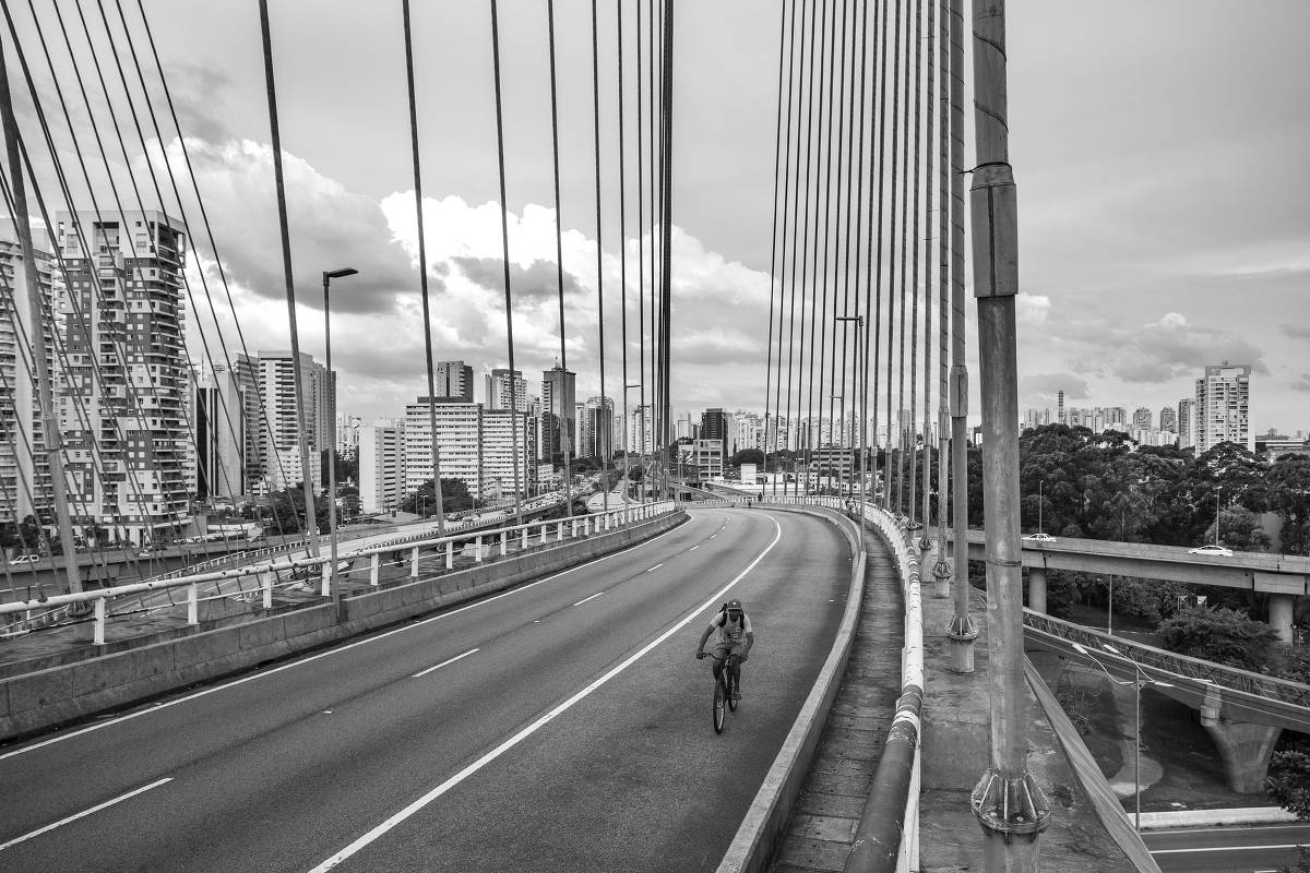 Ciclista atravessa sozinho a ponte Octavio Frias de Oliveira em pleno horário de rush, às 18h30, em 19.mar.2020 