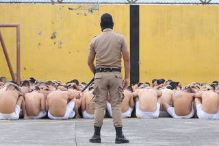 Gang members wait outside their cells during a search at the Ciudad Barrios jail