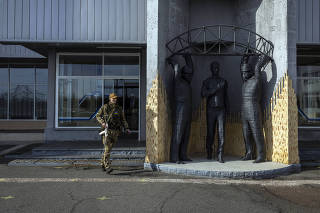 A Ukrainian soldier outside the main station at the Chernobyl nuclear plant in Ukraine on Thursday, April 7, 2022.   (Ivor Prickett/The New York Times)