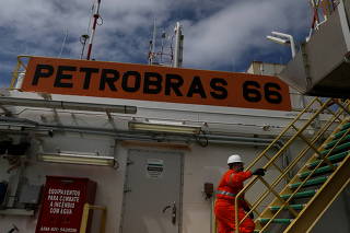 FILE PHOTO: A worker walks inside the Brazil's Petrobras P-66 oil rig in the offshore Santos basin in Rio de Janeiro