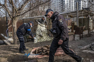 The body of a woman who was shot in the head and found in a cellar in Bucha, Ukraine, April 8, 2022. (Daniel Berehulak/The New York Times)