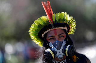 Indigenous Brazilians from different ethnic groups take part in a protest for land demarcation and against President Jair Bolsonaro's government