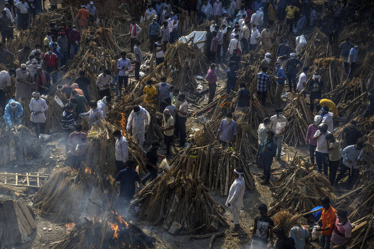 A mass cremation of COVID-19 victims in New Delhi, India, April 26, 2021. Overwhelmed by the pandemic, the country that is a leading maker of vaccines is facing its own crisis at home Ñ and that may be a problem for a world in need of vaccine. (Atul Loke/The New York Times)
