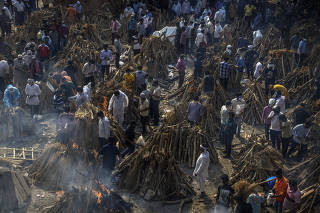 A mass cremation of COVID-19 victims in New Delhi, India, April 26, 2021. (Atul Loke/The New York Times)
