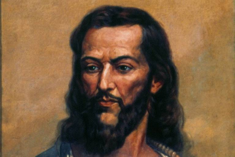 Retrato de Tiradentes. Na imagem, um homem branco de barba e cabelos longos, pretos, olha fixamente para o lado. Há uma corda em volta de seu pescoço.