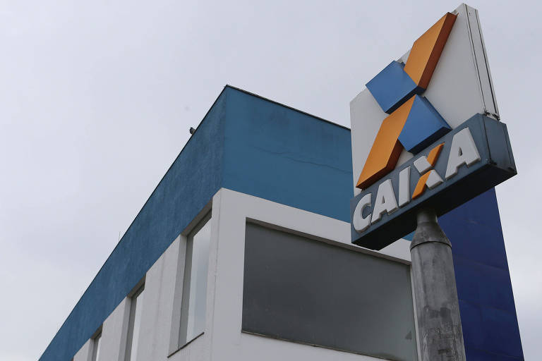 Prédio pintado de branco e azul com o logotipo da Caixa ao lado nas cores branco, laranja e azul