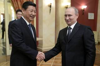 FILE PHOTO: Russia's President Putin shakes hands with his Chinese counterpart Xi before a reception prior to the 2014 Winter Olympic Games opening ceremony in Sochi