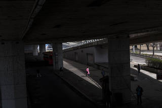 Pedestrians under a bridge in Bratislava, Slovakia, where an investigation exposed how Russian clandestine operations are trying to sow discord in Europe, seen here on April 7, 2022. (Brendan Hoffman/The New York Times)