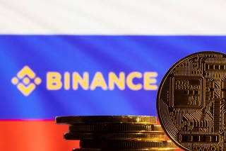 FILE PHOTO: Illustration shows a representation of the cryptocurrency, Binance logo and Russian flag