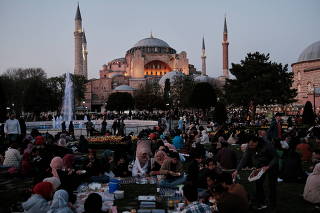 People have their iftar (breaking fast) meal at Sultanahmet Square in Istanbul