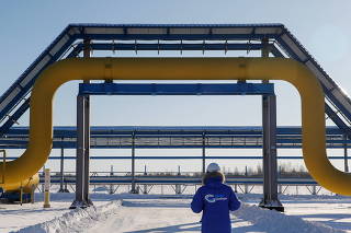 FILE PHOTO: An employee walks past a part of Gazprom's Power Of Siberia gas pipeline at the Atamanskaya compressor station outside the far eastern town of Svobodny