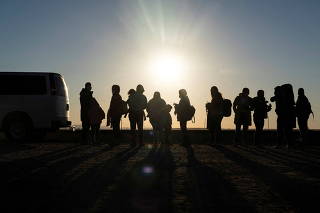 FILE PHOTO: Migrants cross the border in Yuma, Arizona