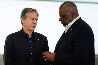 U.S. Secretary of State Antony Blinken and U.S. Secretary of Defense Lloyd Austin talk after speaking with reporters, after returning from their trip to Kyiv and meeting with Ukrainian President Volodymyr Zelenskiy, near the Polish-Ukrainian border