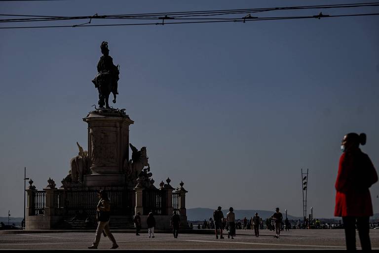 Pedestres caminham na Praça do Comércio, no centro de Lisboa, um dos símbolos do turismo em Portugal; bom desempenho do setor favoreceu alta do PIB lusitano