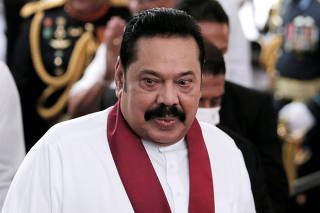 FILE PHOTO: Sri Lanka's Prime Minister Mahinda Rajapaksa reacts during his swearing in ceremony as the new Prime Minister, at Kelaniya Buddhist temple in Colombo