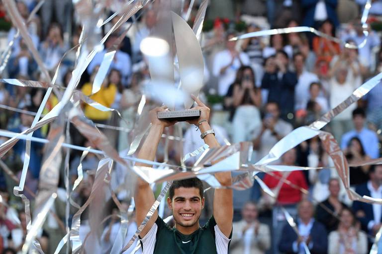 Carlos Alcaraz celebra com o troféu após ganhar o ATP Tour de Madrid 