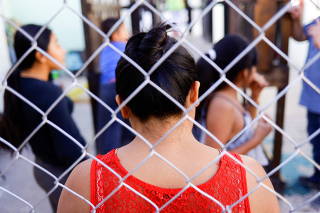 Migrants, who were returned to Mexico under Title 42 after seeking asylum in the U.S., stand inside a shelter, in Ciudad Juarez