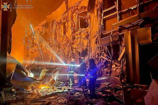 First responders work at the site of a missile strike, in Odesa