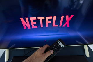 FILE PHOTO: A Netflix logo is shown on a TV screen ahead of a Swiss vote, in this illustration