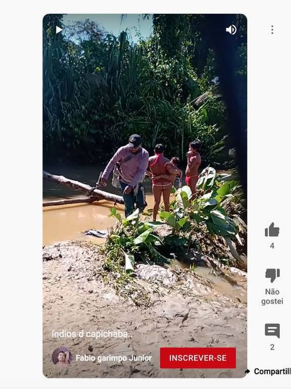 Imagem de reprodução de vídeo mostra dois índios e um outro homem próximo a um rio