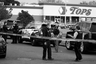 Police officers secure the scene after a shooting at TOPS supermarket in Buffalo