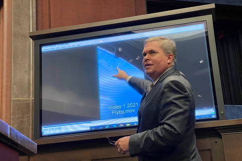 Deputy Director of U.S. Naval Intelligence Scott Bray points to a video of a 'flyby' as he testifies before a House Intelligence Counterterrorism, Counterintelligence, and Counterproliferation Subcommittee hearing about 