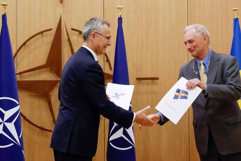NATO Secretary-General Jens Stoltenberg (L) shakes hands with Sweden's Ambassador to NATO Axel Wernhoff (R) during a ceremony to mark Sweden's and Finland's application for membership in Brussels, on May 18, 2022. - Finland and Sweden submitted their applications for NATO membership on May 18, 2022 and consultations were underway between the Allies to lift Turkey's opposition to the integration of the two Nordic countries into the Alliance. (Photo by JOHANNA GERON / POOL / AFP) ORG XMIT: BLR