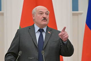 FILE PHOTO: Belarusian President Alexander Lukashenko gestures during a joint news conference with Russian President Vladimir Putin in Moscow, Russia February 18, 2022