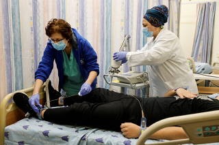 FILE PHOTO: A patient suffering from Long COVID is examined by medical staff in the post-coronavirus disease (COVID-19) clinic of Ichilov Hospital in Tel Aviv