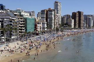 People visit the beach in the Spanish south-eastern town of Benidorm