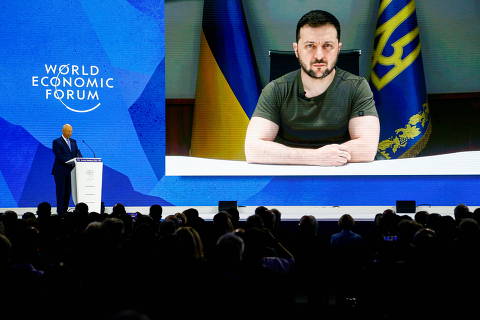 Ukrainian President Volodymyr Zelenskiy is seen on a screen as he delivers a video address to the delegates of the World Economic Forum (WEF)  in Davos, Switzerland May 23, 2022. REUTERS/Arnd Wiegmann ORG XMIT: GDN