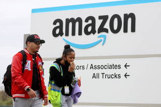 FILE PHOTO: Amazon workers walk outside Amazon?s LDJ5 sortation center in Staten Island, New York